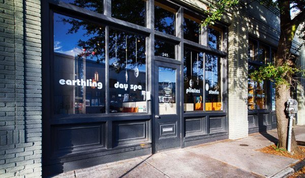 An outside view of the spa in downtown Charleston, SC. Large windows face the street with black wood trim.